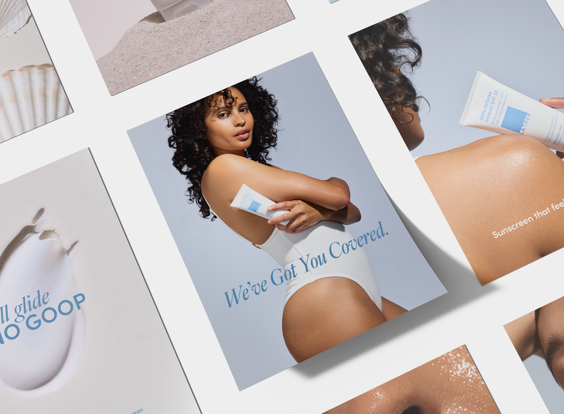Angled flat lay of five LATHER campaign print pieces: a seashell resting in sand, a sculptural close-up of the sunscreen tube, a woman in a white swimsuit hugging the tube above the line 'We've Got You Covered,' a hand pressing the tube to a sunlit shoulder, and a close-up smear of white sunscreen cream.