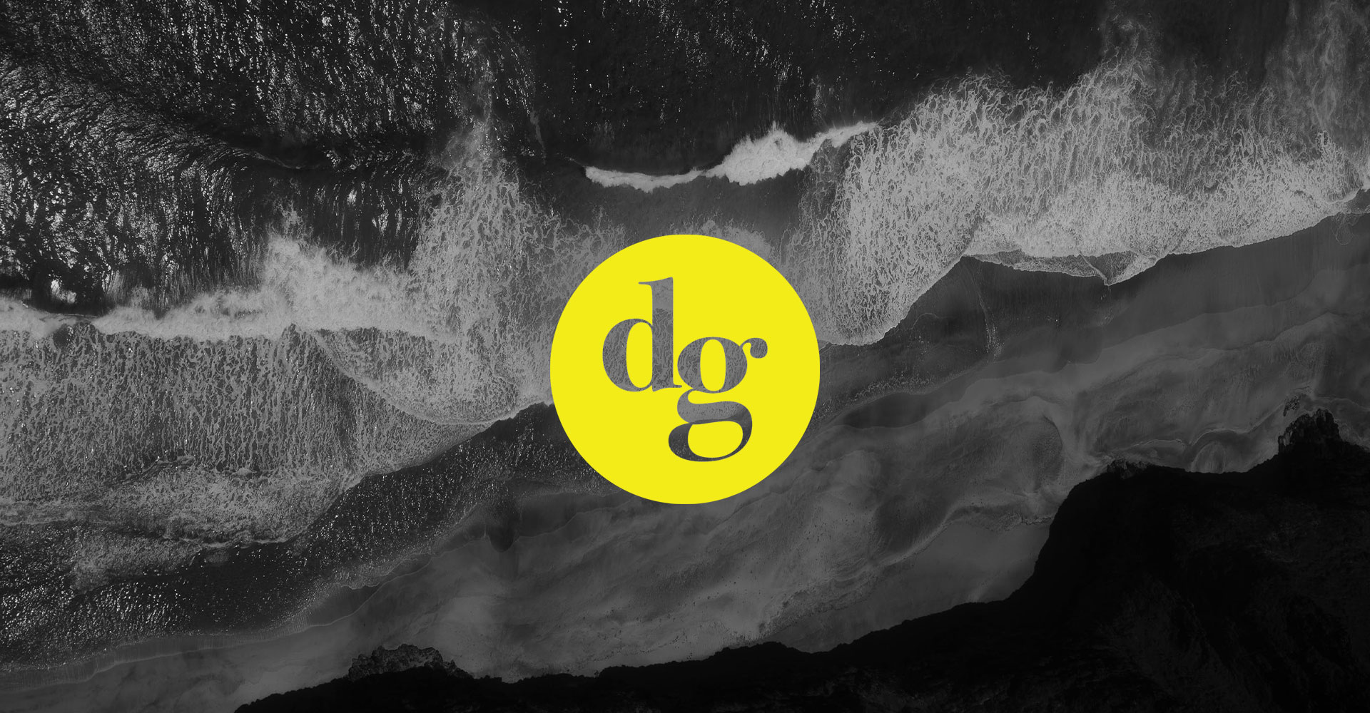 Lowercase 'dg' logo in a bright yellow circle, set against a black-and-white aerial photo of ocean waves breaking on rocks.